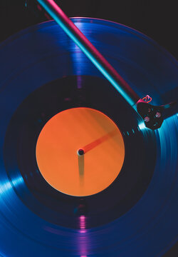 Record player needle and vinyl in neon light