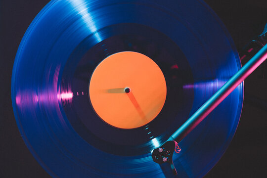 Turntable tonearm over spinning vinyl record