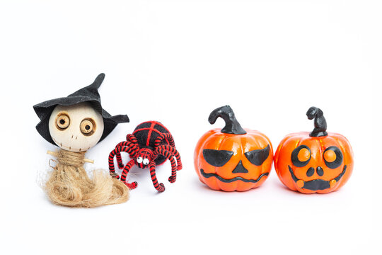Cute little wooden witch doll and black yarn spider with funny face pumpkin isolate on white background, Halloween decorate item