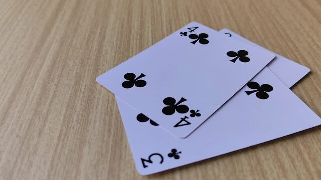 Dealing cards at the table, revealing the poker playing cards.