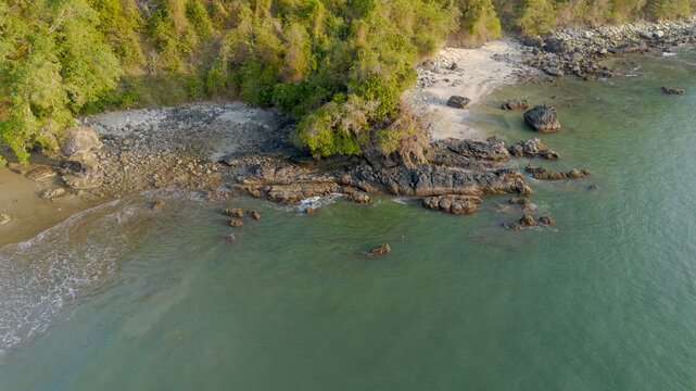 Aerial panoramic view of Pujiharjo beach bay surrounded by green hills in Malang East Java