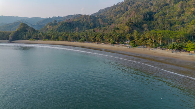 Aerial panoramic view of Pujiharjo beach bay surrounded by green hills in Malang East Java