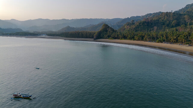 Aerial panoramic view of Pujiharjo beach bay surrounded by green hills in Malang East Java