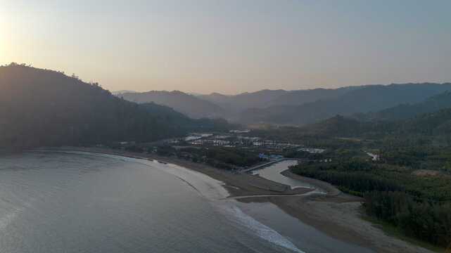 Aerial panoramic view of Pujiharjo beach bay surrounded by green hills in Malang East Java