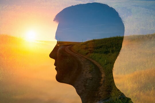 Silhouette of a man in profile with double exposure sunrise landscape art for creative mind concept