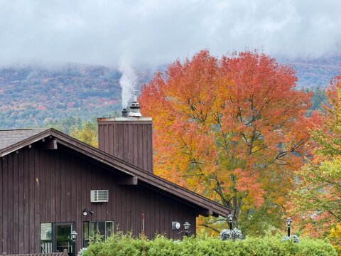 Smoke from a chimney and Autumn fall foliage colors in Vermont, USA