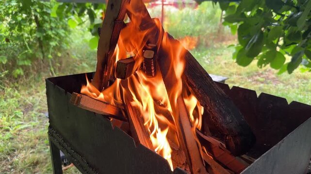 Close-up of a fire in a barbecue grill, outdoor recreation. High quality 4k footage
