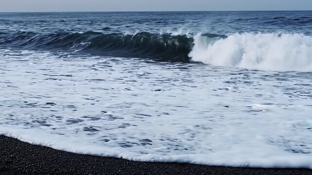 Ocean waves crashing on black sand beach: dramatic coastal nature scene