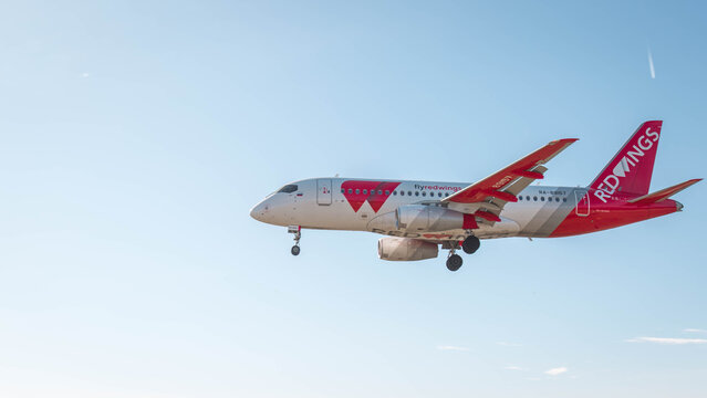 27.01.2026, Batumi, Georgia: Red Wings passenger aircraft approaching for landing against clear blue sky, commercial aviation scene featuring modern jetliner, air travel, transportation industry,