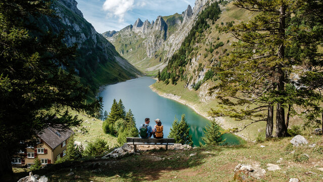 Nestled in Appenzell, Switzerland, the stunning Falensee captures the essence of nature. Hikers enjoy a tranquil moment by the lake, surrounded by towering mountains and lush greenery.