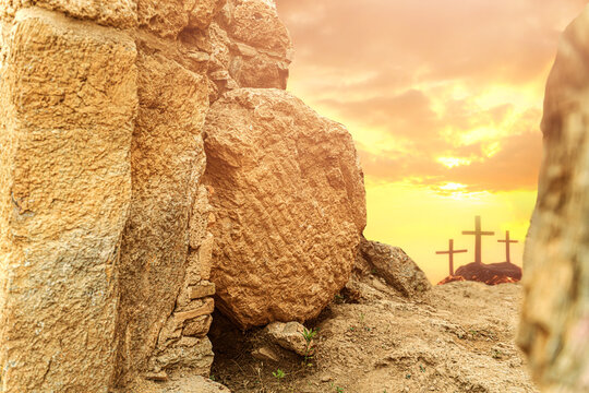 Empty Tomb of Jesus with Rolled Stone and Three Crosses at Sunrise
