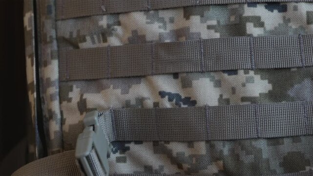 Close up of Ukrainian military backpack with trident emblem and flag patch