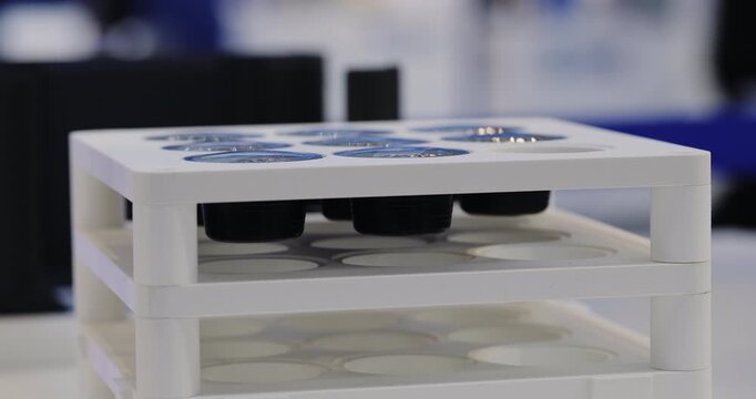 Used coffee pods with aluminum foil lids are processed by automated equipment. Sustainable recycling solution for reducing capsule waste from modern coffee consumption.