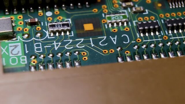 View of a part of an electronic printed circuit board with components and a microcircuit, video macro shooting