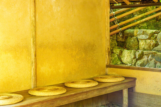 Traditional Japanese Rest Area with Mud Wall and Round Straw Cushions