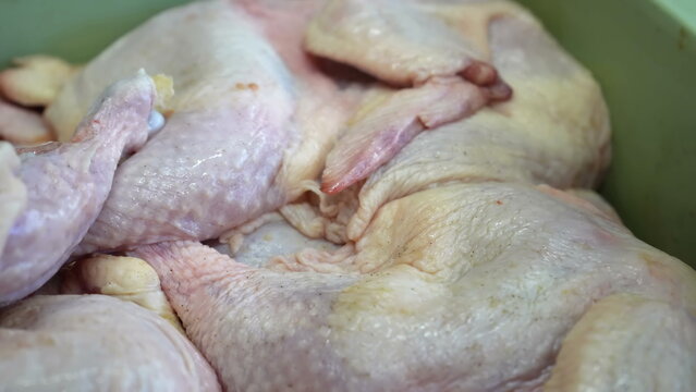 Close up view of raw poultry meat showcasing texture and internal structure during preparation inside a professional commercial kitchen environment