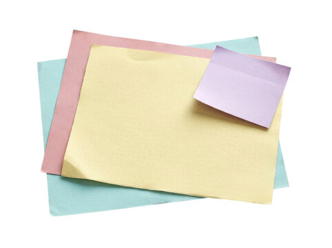 Colorful sticky notes and paper sheets stacked on a flat surface