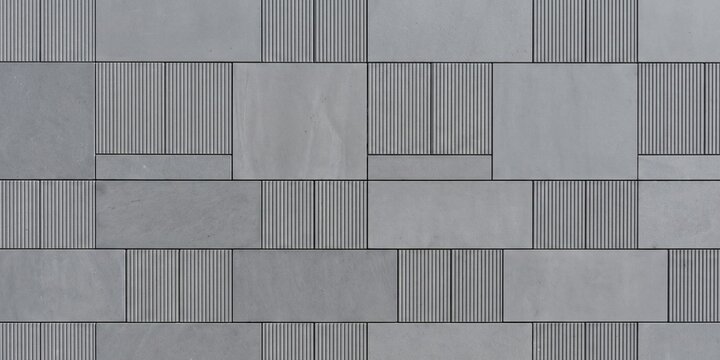 modern gray concrete tile wall with alternating smooth and fluted textures. geometric industrial stone pattern, modular architectural cladding for contemporary interior design.

