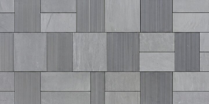 modern gray concrete tile wall with alternating smooth and fluted textures. geometric industrial stone pattern, modular architectural cladding for contemporary interior design.

