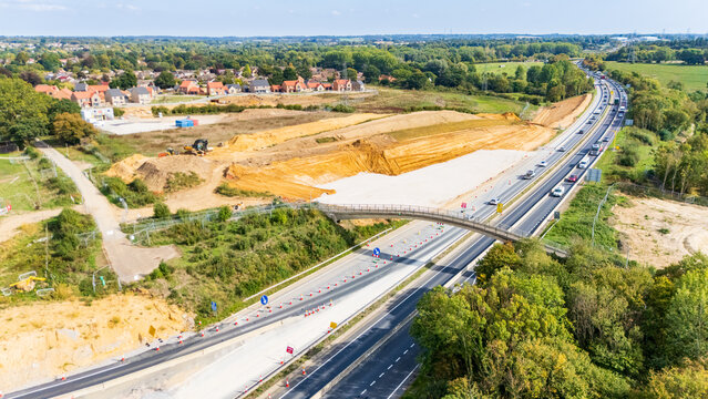 A view of the roadworks at the Thickthorn Interchange showing lanes rerouted and a new house construction site near the road