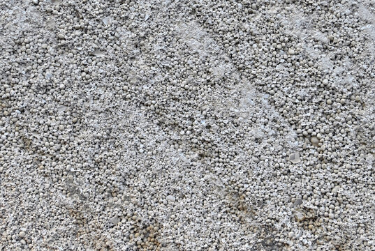 Grey background with plaster from concrete granules