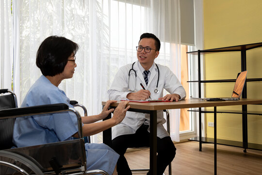 Doctor consulting older woman in wheelchair at clinic, discussing healthcare, treatment, diagnosis, medical support and patient care during appointment