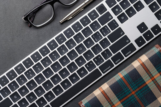 Office supplies on dark leather desk