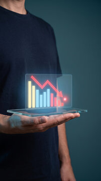 Digital red candlestick chart displaying falling market trend above tablet. Global economy finance market. stock investment trading candleholder, graph analysis risk loss profit