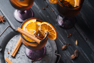Fototapeta premium White mulled wine with citrus and spices in glasses for autumn and Christmas drinks