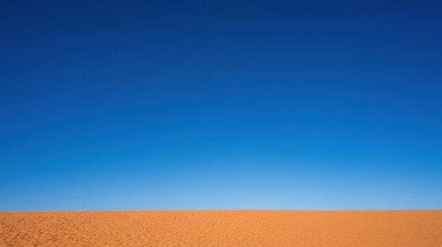 Minimal abstract landscape of warm orange sand forming a thin lower band beneath an immense flat cobalt-blue sky, modern color-field photography, clean horizon, bold complementary palette and spacious