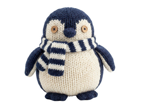 Knitted penguin toy with a striped scarf isolated on transparent background