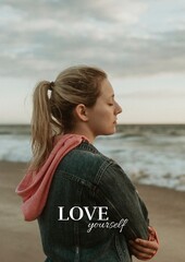 Obraz premium Woman with closed eyes on a beach, wearing a denim jacket.