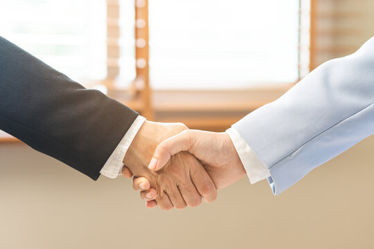 Successful deal asian young business woman, partnership, teamwork handshake or greeting together at office after project done, good deal. Happy business people, group meeting, colleagues shaking hands