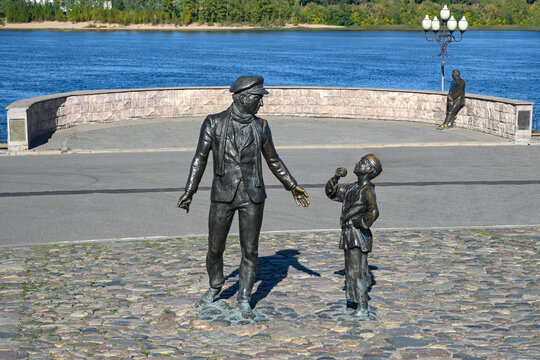 RYBINSK, RUSSIA - SEPTEMBER 15, 2026: Monuments to Ostap Bender and L.I. Oshanin on the background of the Volga. Rybinsk, Yaroslavl region