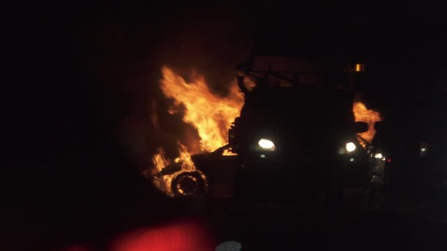 Berridale, New South Wales, Australia - September 29, 2026: Car on fire burning on side of Kosciuszko Road just north of Berridale with emergency crews attending