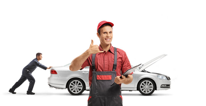 Garage workers pushing a broken down car