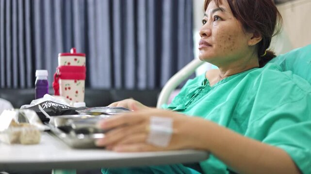 Close up of patient hand with IV catheter line on hospital bed