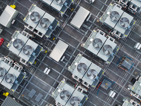 Aerial view of a data center roof featuring a grid of industrial cooling fans and HVAC units in the United Kingdom.