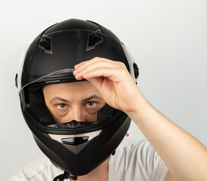 Serious man in black moto helmet