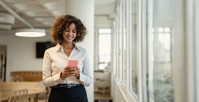 Web banner of indian business woman texting on mobile phone in coworking office workplace, using smartphone app. In 30s, female ceo works as boss, leader, specialist, consultant, director. Copy space