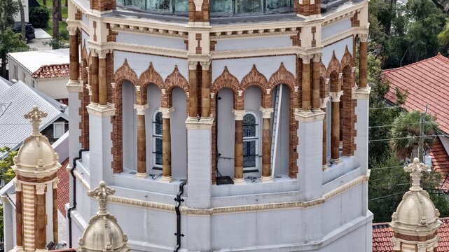 Aerial view of the ornate dome and architectural details of the Memorial Presbyterian Church, featuring intricate brickwork and arched windows in St. Augustine, Florida, United States.