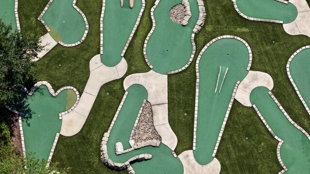 Aerial view of the miniature golf course at Windward Ranch Boulevard with green artificial turf, concrete pathways, and stone obstacles in St. Johns County, Florida, United States.