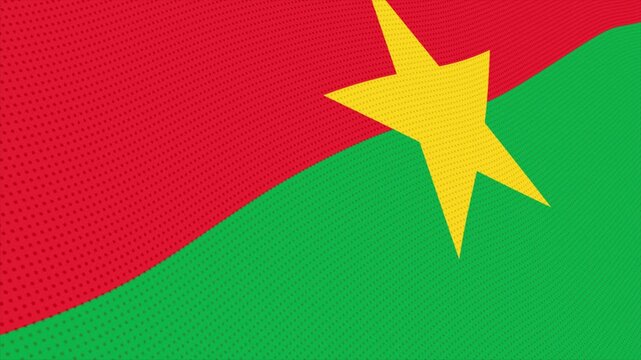 Flag of Burkina Faso waving slowly in the foreground and moving upwards.