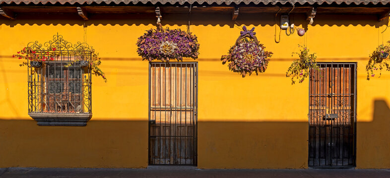 Yellow colonial style facade panorama in Antigua, Guatemala.