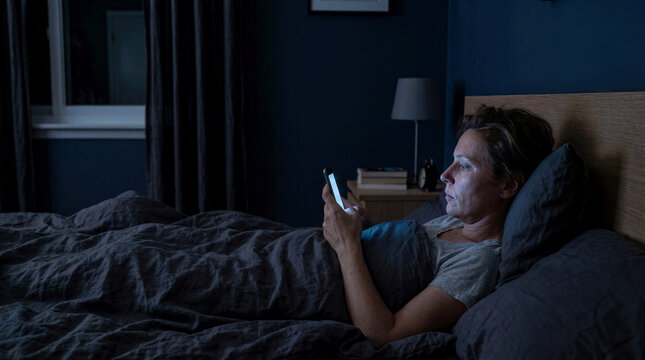 Digital Burnout Concept Exhausted Woman Using Smartphone Late At Night In Bed Suffering From Tech Fatigue Eye Strain Sleep Deprivation Insomnia And Digital Overload Stress Causing Mental Health Issues