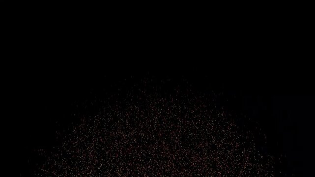 Dark textured granules gather at the bottom of the frame under a dim ambient light.