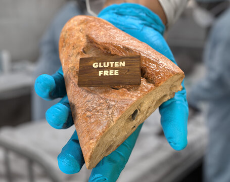 Baker or food inspector with protective gloves holding gluten-free artisan bread loaf with wooden label
