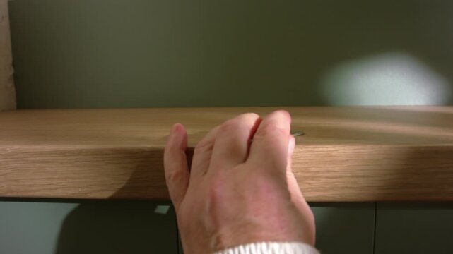 Hand grabbing money coins of table