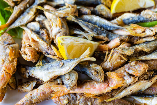 little local fried fishes close-up on plate