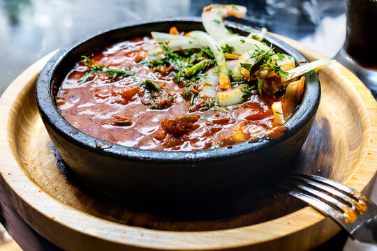 Georgian meat dish Ostri in ketsi pan close-up